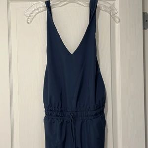 V neck jumpsuit with side zippers at ankles